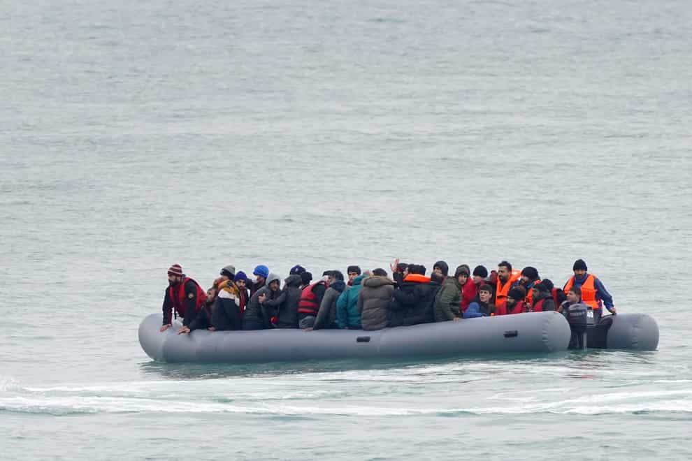 A group of people thought to be migrants adrift in a dinghy before being rescued off the coast of Folkestone, Kent (PA)