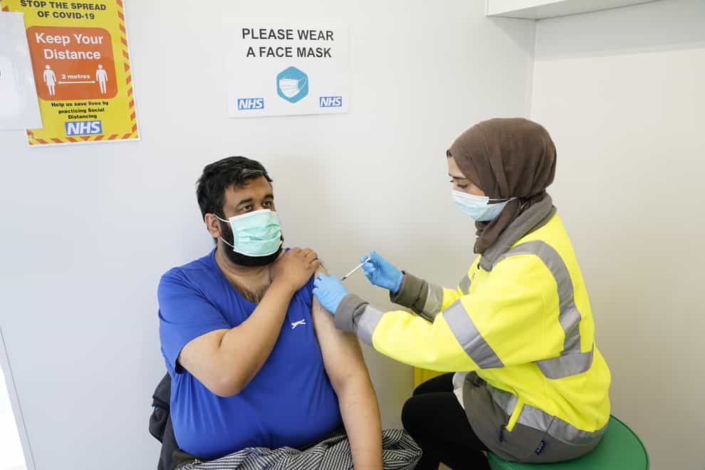 Riswan Mahmood receives his Covid-19 vaccination at the Penny Street vaccination centre in Blackburn. Experts in the UK are quickly trying to work out how quickly a new South African variant may spread and whether it is more deadly.