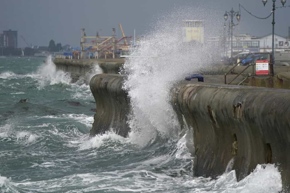 Waves crash against the sea walls in Southsea, Hampshire (PA)