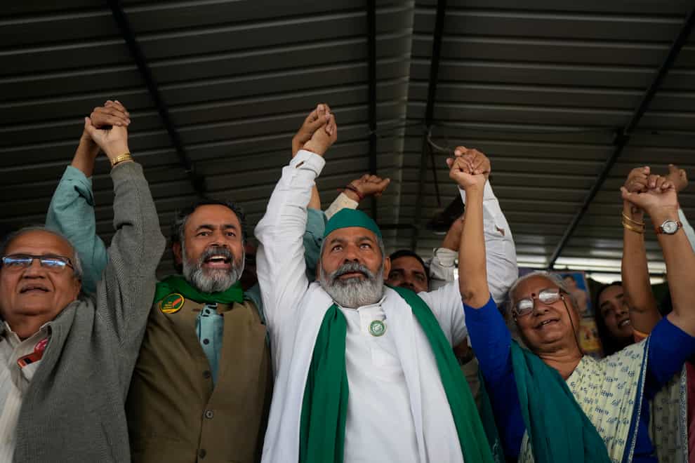 Farmer leader Rakesh Tikait, centre, and others celebrate during a rally at Ghazipur, on the outskirts of New Delhi, to mark one year of their movement (Manish Swarup/AP)