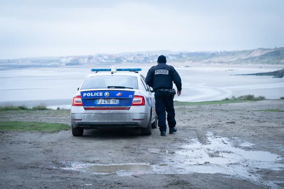 French police look out over a beach near Wimereux in France (Stefan Rousseau/PA)