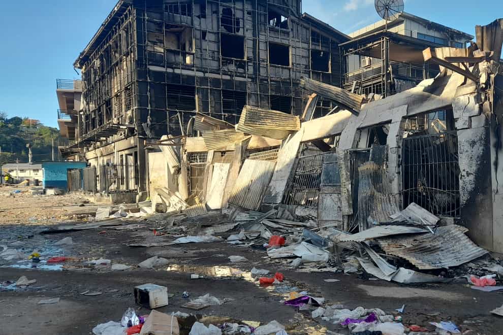 This photo shows aftermath of a looted street in Honiara’s Chinatown, Solomon Islands, Saturday, Nov. 27, 2021. Violence receded Friday in the capital of the Solomon Islands, but the government showed no signs of addressing the underlying grievances that sparked two days of riots, including concerns about the country’s increasing links with China. (AP Photo/Piringi Charley)