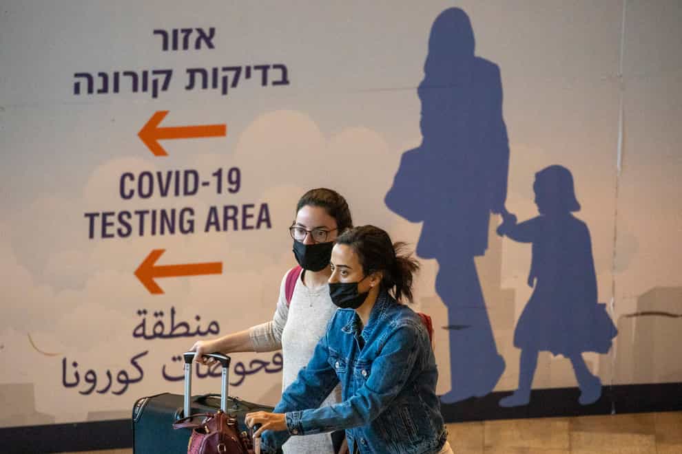 Israel has approved barring entry to foreign nationals and the use of controversial technology for contact tracing as part of its efforts to crack down on a new coronavirus variant (Ariel Schalit/AP)