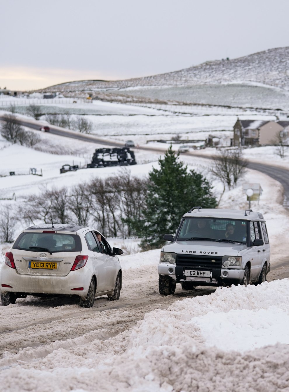 Vehicles travel tentatively on the snow-covered A53 close to Buxton, Derbyshire (Jacob King/PA)
