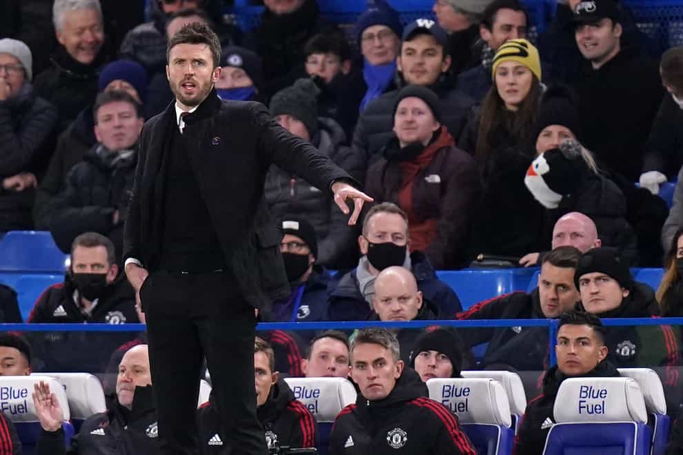 Manchester United caretaker manager Michael Carrick on the touchline as Cristiano Ronaldo (front right) sits on the bench during the Premier League match at Stamford Bridge, London. Picture date: Sunday November 28, 2021.