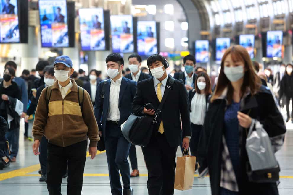 People wearing face masks in Tokyo (Koji Sasahara/AP)