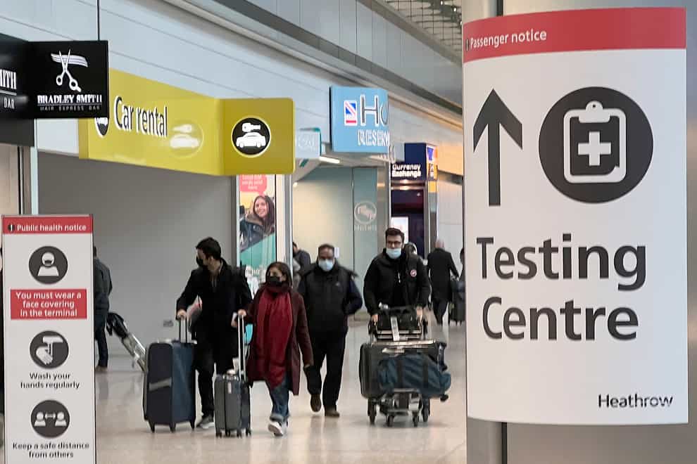 Passengers arrive at Heathrow Airport in London as travel restrictions return because of the new variant of coronavirus (Frank Augstein/AP)