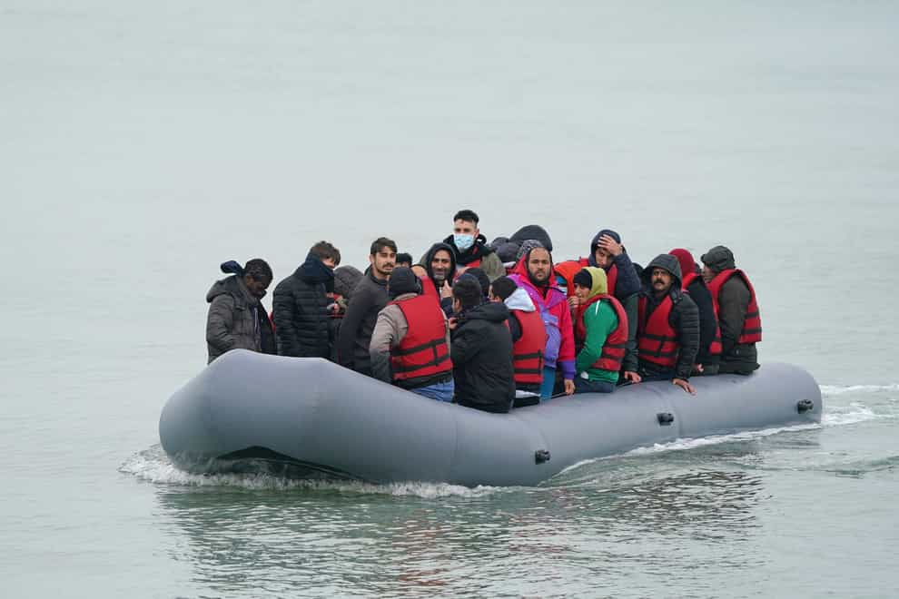 A dinghy carrying people thought to be migrants, arrives on a beach in Dungeness, Kent (Gareth Fuller/PA)