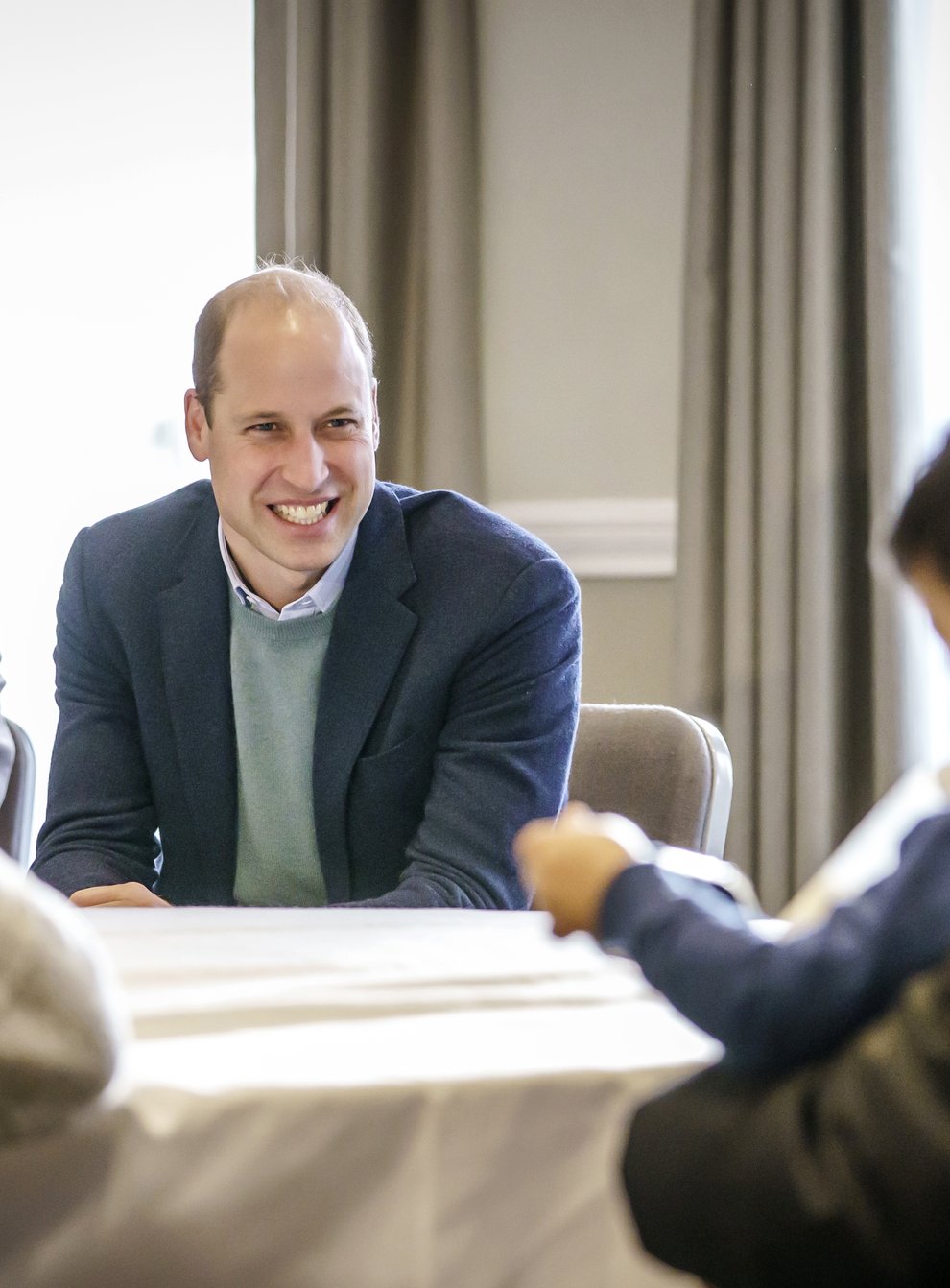 The Duke of Cambridge speaks to refugees during a visit to a local hotel in Leeds, which is being used to accommodate refugees evacuated from Afghanistan (PA)