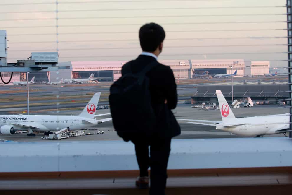 Japan has suspended new reservations on all incoming flights for a month to guard against new virus variant (AP Photo/Koji Sasahara)