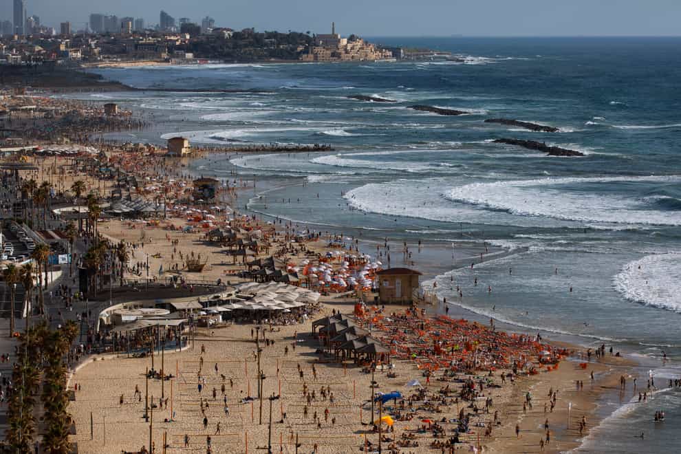 People on the beachfront in Tel Aviv (Oded Balilty/PA)