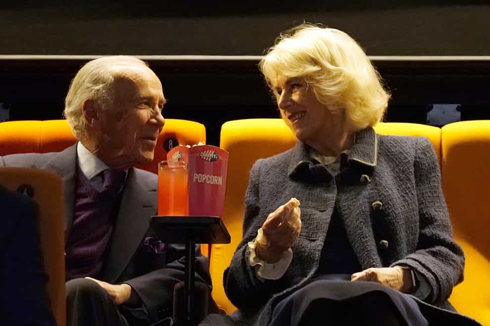 The Duchess of Cornwall enjoys popcorn alongside philanthropist Robert Hiscox (PA)