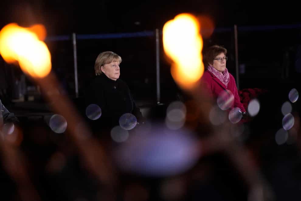 Chancellor Angela Merkel, left, sits next to defence minister Annegret Kramp-Karrenbauer (Markus Schreiber/AP)