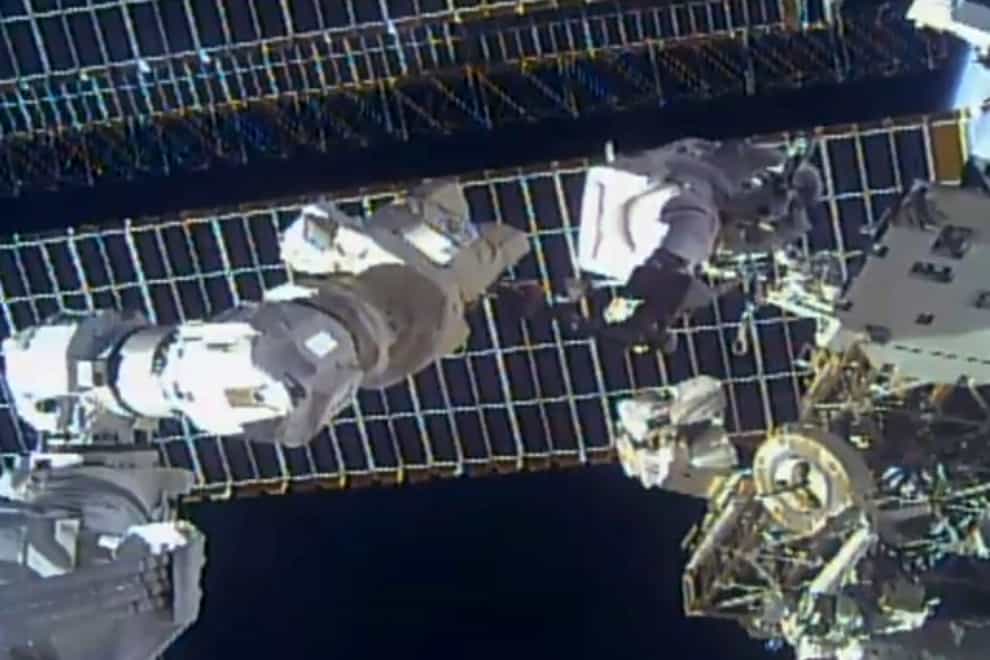 Astronaut Tom Marshburn replaces a broken antenna (Nasa/AP)