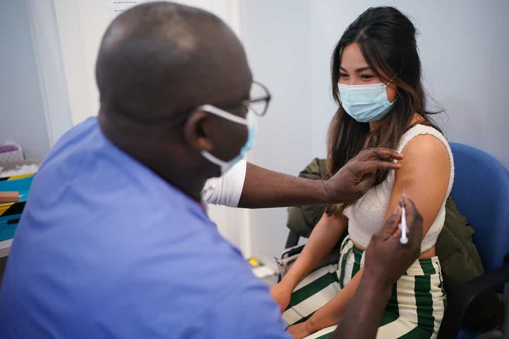 Kyna Bigornia receives her Pfizer Covid-19 booster injection at a vaccination site in Liberty Shopping Centre, Romford, east London, as the Government accelerates the Covid booster programme to help slow down the spread of the new Omicron variant (Yui Mok/PA)