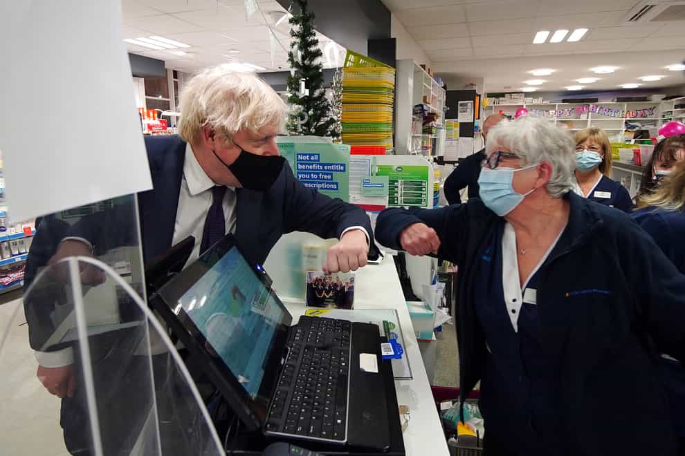 Prime Minister Boris Johnson meets staff during a visit to a pharmacy in the North Shropshire constituency (Peter Byrne/PA)