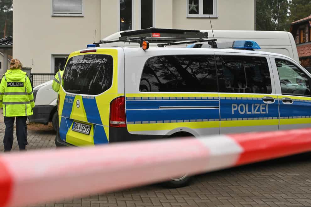Police have cordoned off a single-family home in Senzig, a district of the town of Kownigs Wusterhausen in the Dahme-Spreewald district, Saturday, Dec.4, 2021. Police found five dead bodies in a home there. The police assume a homicide, a spokesman said. (Patrick Pleul/dpa via AP)