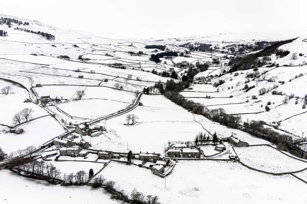 Snow covers fields and hills in the Arkengarthdale valley, North Yorkshire (PA)
