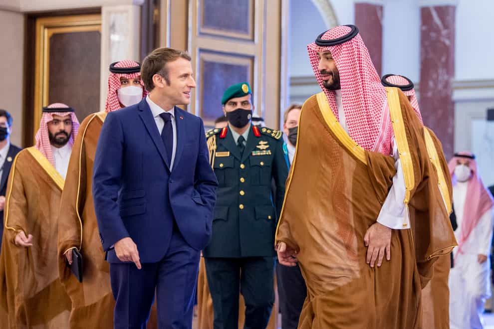 Saudi Crown Prince Mohammed bin Salman greets French President Emmanuel Macron in Jiddah (Saudi Royal Palace via AP)