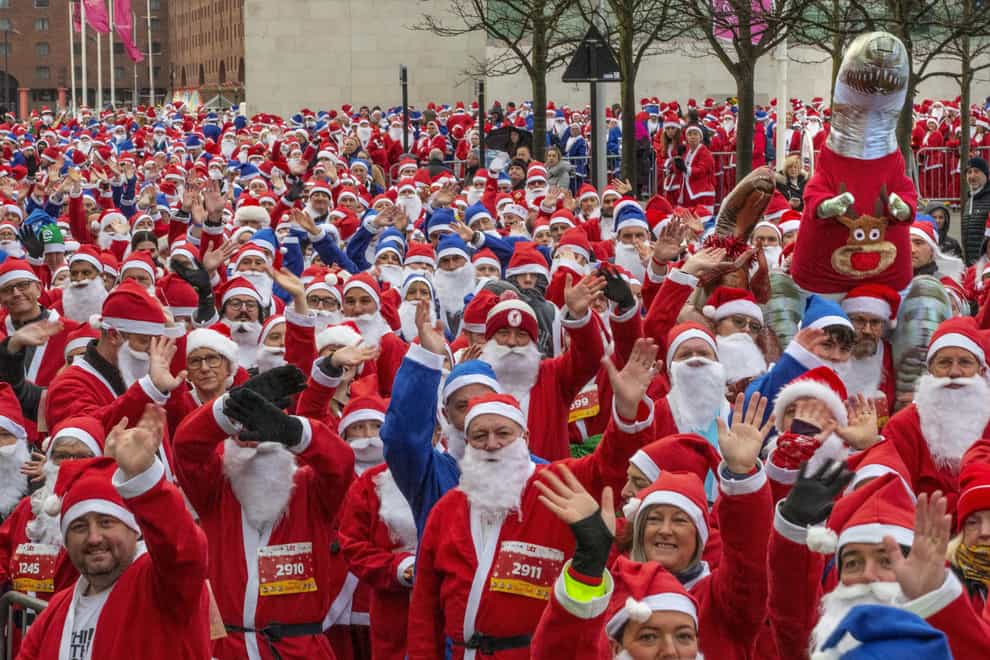 Participants taking part in the Liverpool Santa Dash in Liverpool in aid of Alder Hey Children’s Hospital (Jason Roberts/PA)