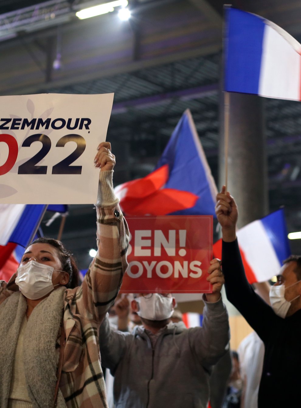 Supporters of French presidential candidate Eric Zemmour wave posters and flags during the candidate’s first rally (Rafael Yaghobzadeh/AP)