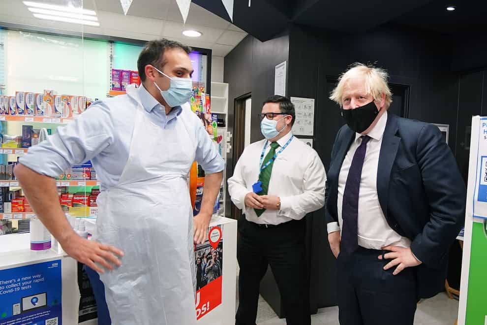 Prime Minister Boris Johnson meets staff during a visit to a pharmacy in the North Shropshire constituency ahead of the by-election following the resignation of Conservative MP Owen Paterson (PA)
