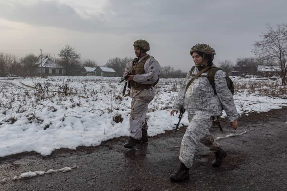 Ukrainian soldiers walk at the line of separation from pro-Russian rebels near Katerinivka, Donetsk region (AP)
