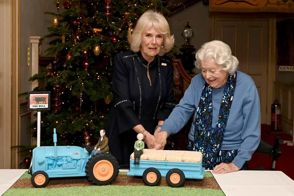 Duchess of Cornwall and actress June Spencer cut an Archers themed cake during a reception to celebrate the 70th anniversary of The Archers (Kate Green/PA)