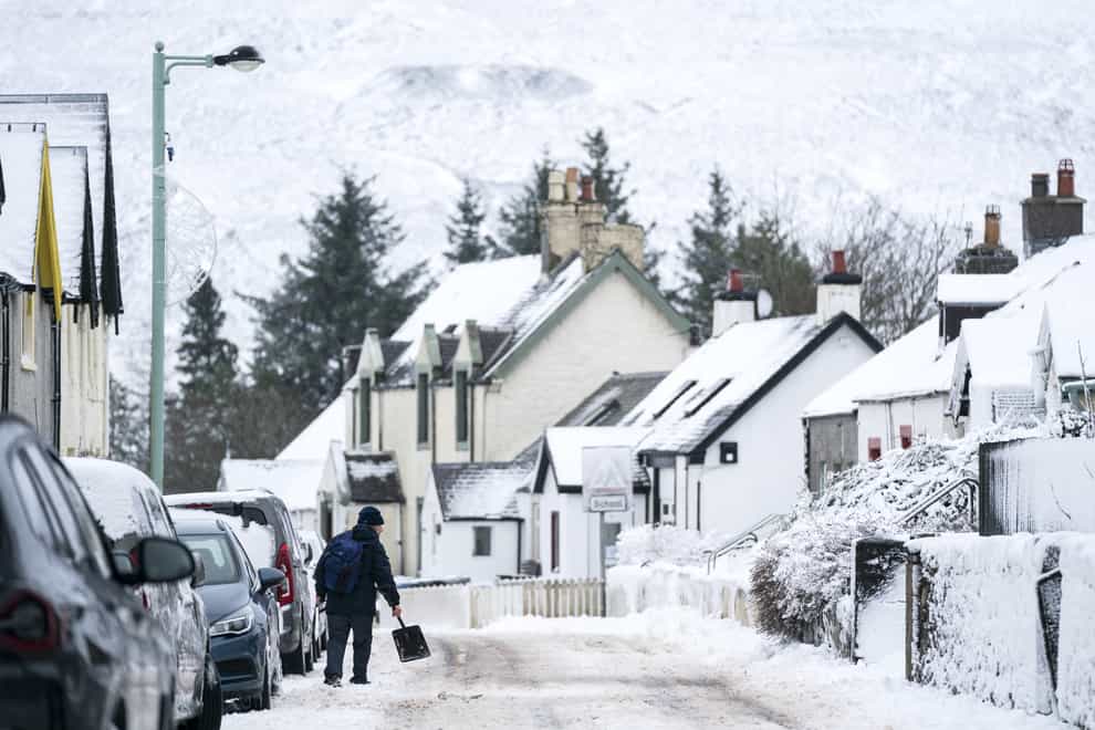 A man clears snow in Leadhills, South Lanarkshire as Storm Barra hits the UK and Ireland with disruptive winds, heavy rain and snow (PA)