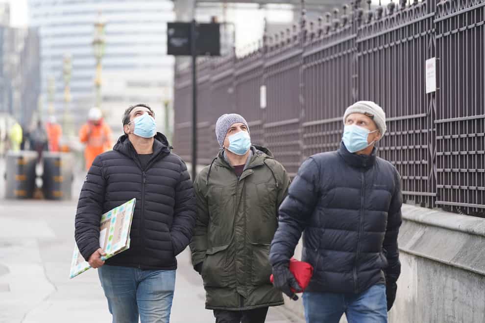 Face masks were again made mandatory in shops and public transport in England following the emergence of the Omicron variant (PA)
