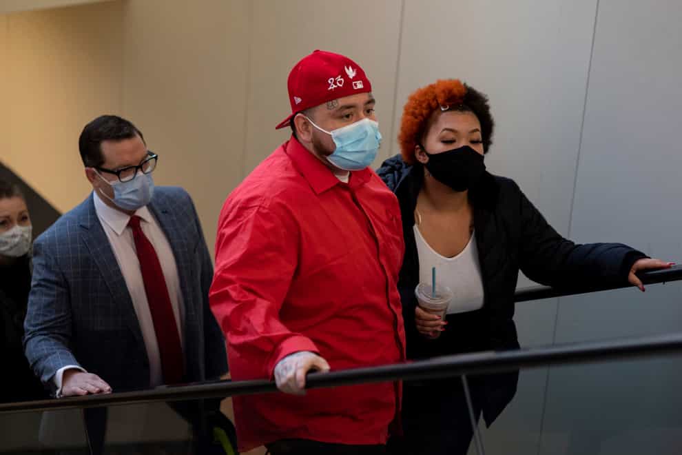 Lawyers Jeff Storms, left, accompanies the family of Daunte Wright as they arrive at the Hennepin County Government Centre in Minneapolis (Christian Monterrosa/AP)