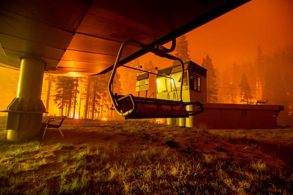 A father and son have been arrested accused of starting the fire which destroyed homes and a ski resort near Lake Tahoe, California (AP Photo/Noah Berger, File)