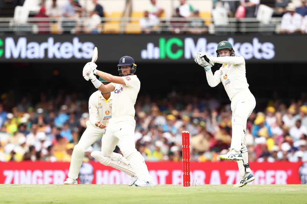 England’s Dawid Malan (left) plays a shot as Australia’s Alex Carey looks on during day three of the first Ashes test at The Gabba, Brisbane (Jason O’Brien/PA)