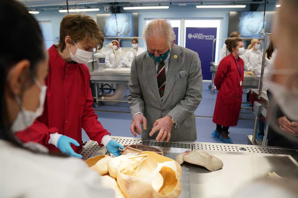 The Prince of Wales talks to students during a visit to open Aberystwyth University’s new School of Veterinary Science (Jacob King/PA)