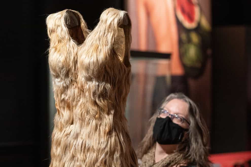 A visitor views ‘Blond hair dress’ by artist Jenni Dutton, made with discarded hair, part of the Horniman Museum (Dominic Lipinski/PA)