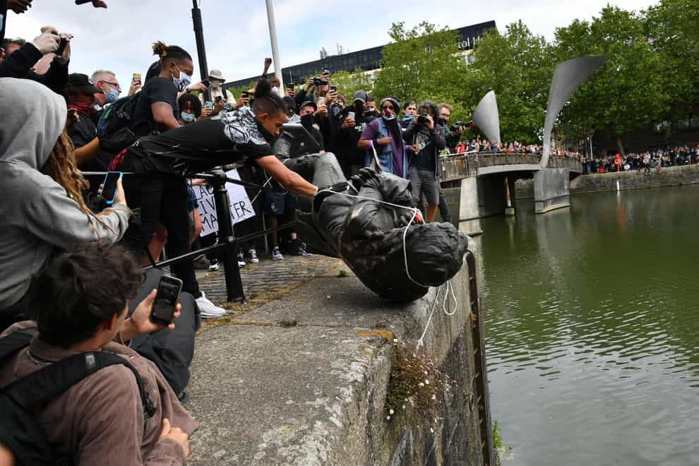 Protesters throw a statue of Edward Colston into Bristol harbour during a Black Lives Matter protest (Ben Birchall/PA)