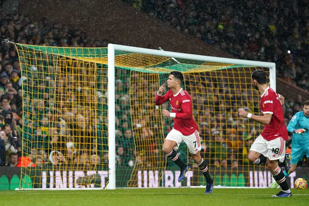 Manchester United’s Cristiano Ronaldo (left) celebrates scoring at Norwich (Joe Giddens/PA)