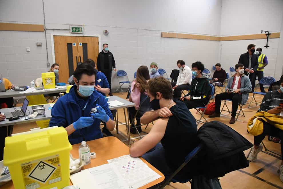 People receiving their Covid booster jabs at the Stow Health Vaccination centre in Westminster (Jeremy Selwyn/Evening Standard/PA)