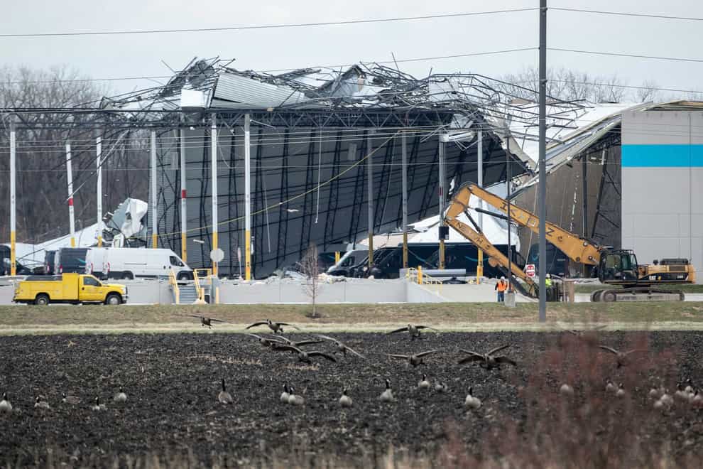 Crews move in heavy equipment for search and rescue operations at the Amazon distribution centre in Edwardsville (Daniel Shular/St. Louis Post-Dispatch via AP)