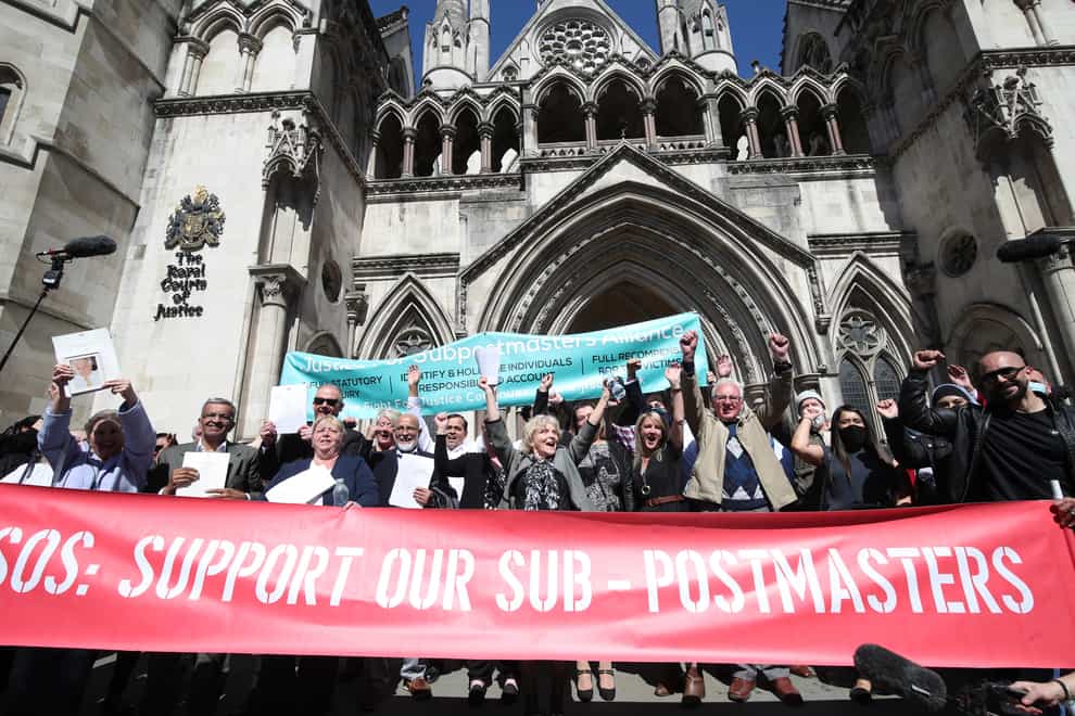 Former post office workers celebrate outside the Royal Courts of Justice, London (Yui Mok/PA)