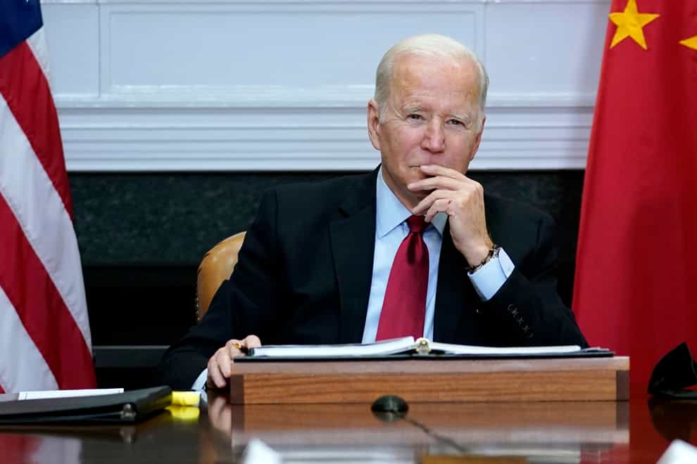 US President Joe Biden meets virtually with Chinese President Xi Jinping from the White House in Washington (Susan Walsh/AP)