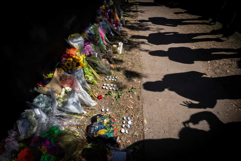 Visitors cast shadows at a memorial to the victims of the Astroworld concert crush in Houston (Robert Bumsted/AP)