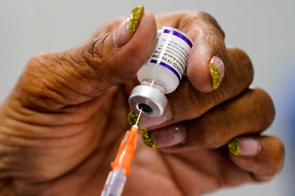 A syringe is prepared with the Pfizer Covid-19 vaccine (Matt Rourke/AP)