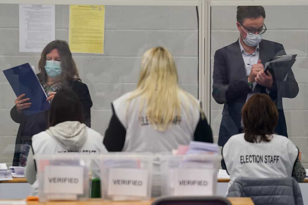 Observers watch election staff sorting votes during the count for the North Shropshire by-election at Shrewsbury Sports Village (Jacob King/PA)