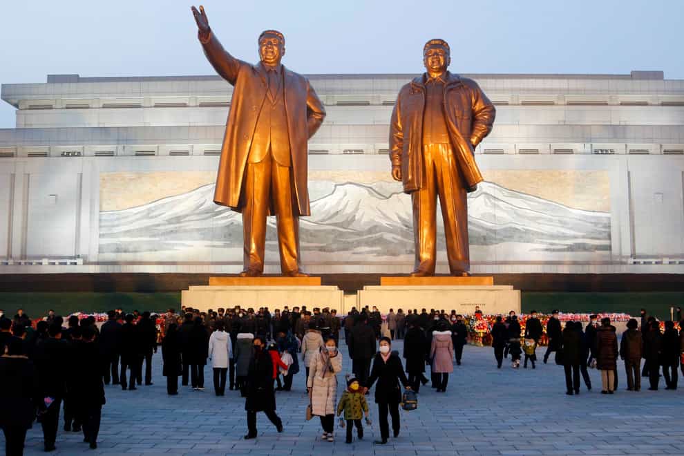 Citizens visit the bronze statues of their late leaders Kim Il Sung, left, and Kim Jong Il on Mansu Hill in Pyongyang (Cha Song Ho/AP)