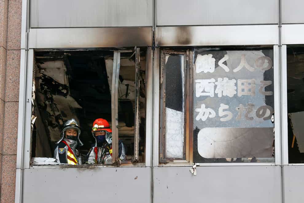 Firefighters at the building in Osaka (Kyodo News/AP)