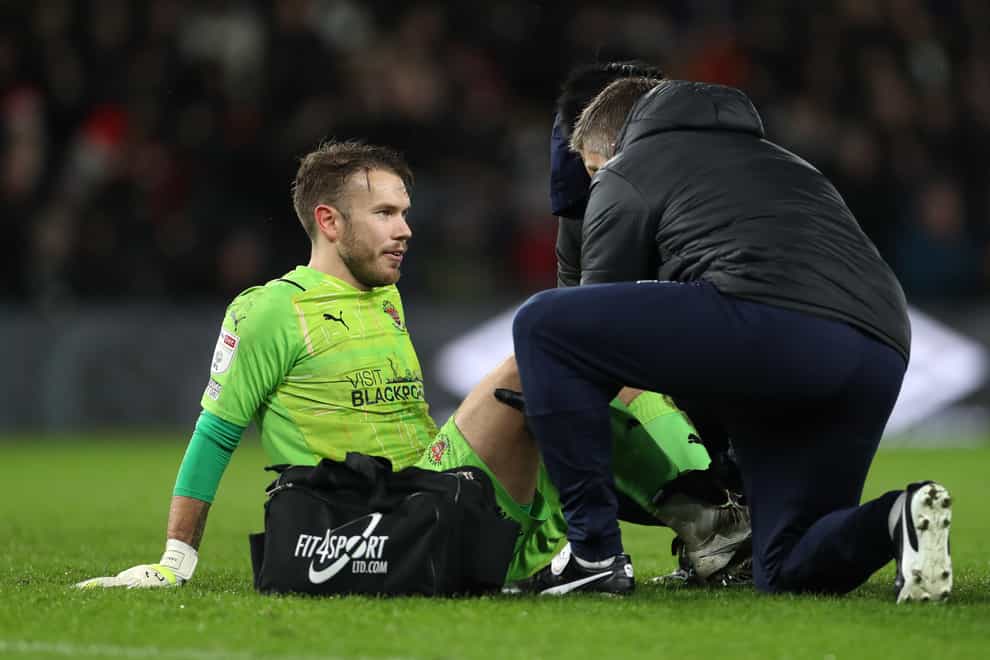 Chris Maxwell receives treatment after reinjuring his thigh against Derby (Bradley Collyer/PA)