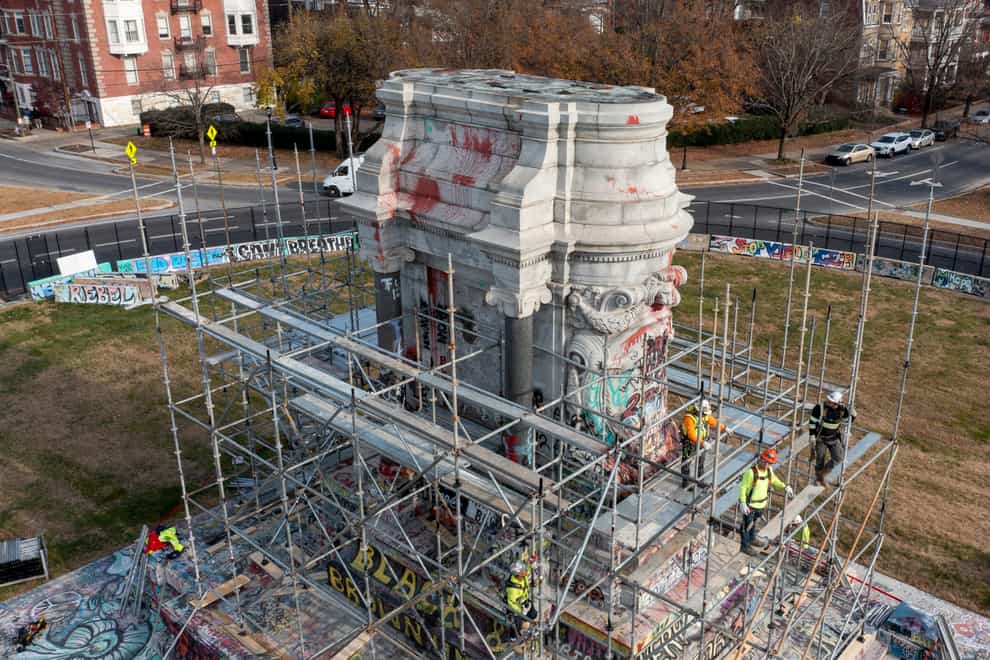 Workers install scaffolding as they prepare to remove the pedestal that once held the statue of Confederate General Robert E. Lee on Monument Avenue Monday Dec 6, 2021, in Richmond, Va. Virginia Gov. Ralph Northam ordered the pedestal removed and the land granted to the City of Richmond. (AP Photo/Steve Helber)