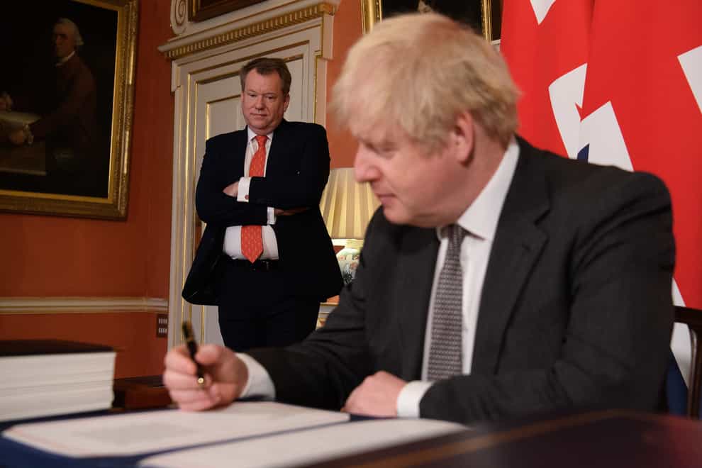 Lord Frost looks on as Prime Minister Boris Johnson signs the EU-UK Trade and Cooperation Agreement (Leon Neal/PA)