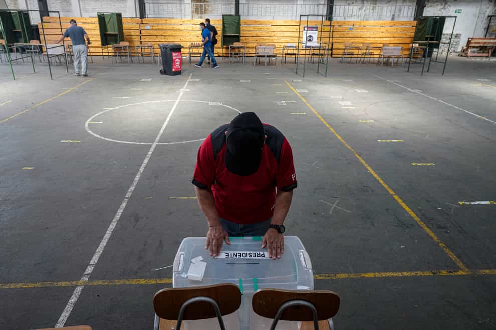 Electoral workers prepare a school to be a polling station in Santiago, Chile (Esteban Felix/AP/PA)